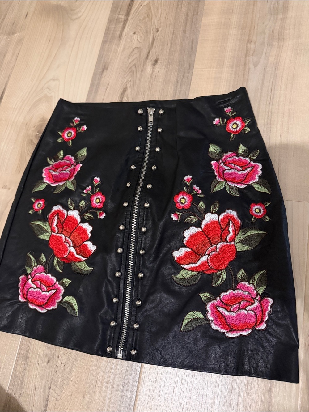 Size small faux leather skirt with flower detail